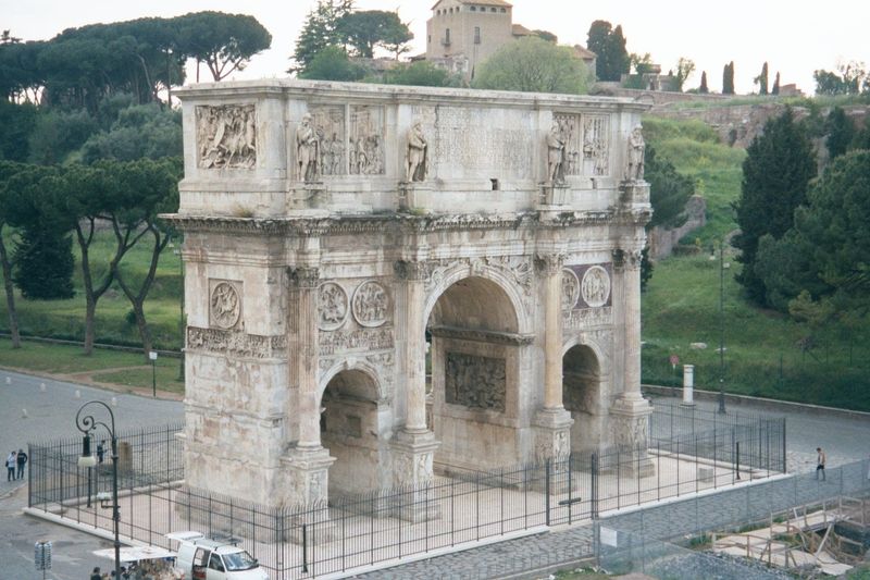 Flanking the Colosseum on the west, the Arch of Constantine is seen here from an upper level of the Colosseum. The Palatine Hill is in the b
