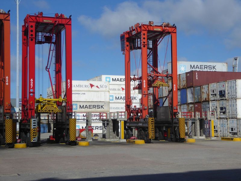 Stacker cranes. The port is largely operated by a government agency, but outsiders are muscling in. There's not quite enough room for Maersk