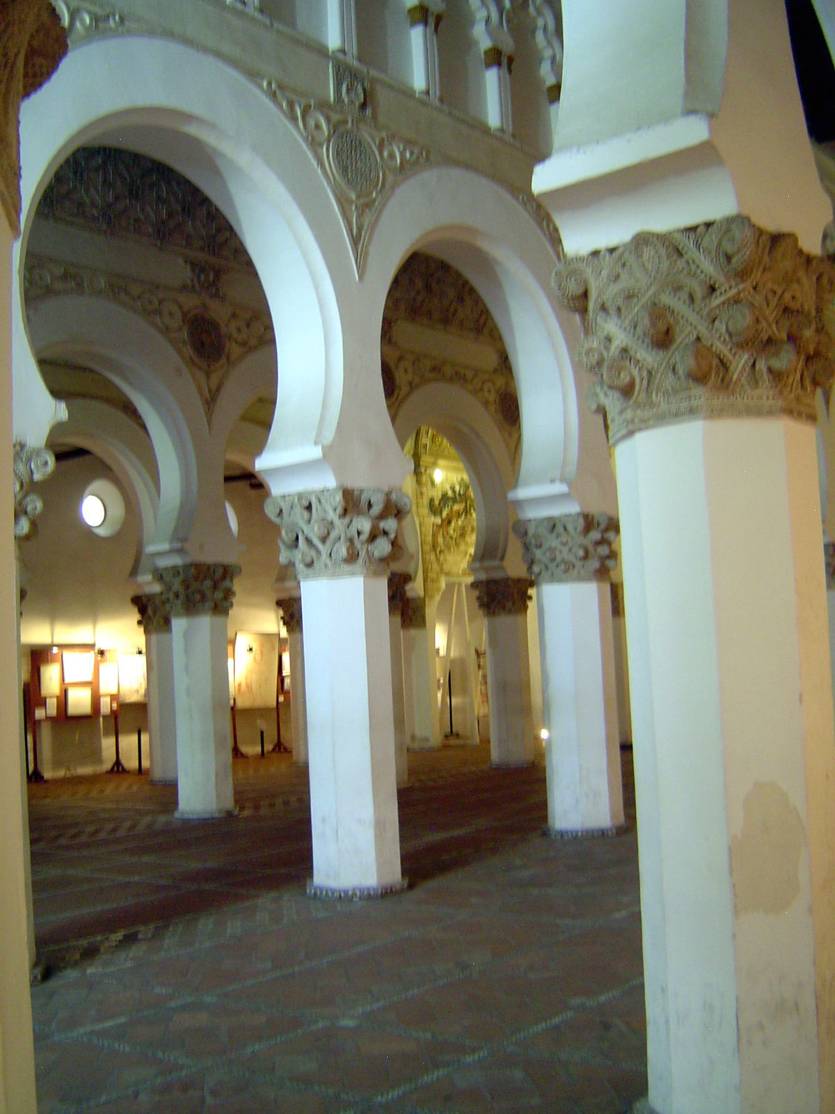 Ford writes of "aisles divided by polygonal pillars, which support horseshoe arches, springing from bastard Gothic capitals...."