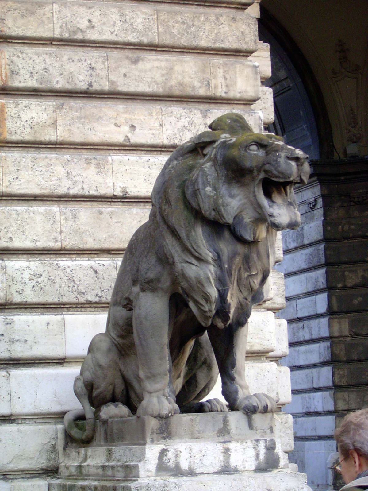 Around the corner, another lion, supposedly menacing but perhaps merely laughing at his stuffy neighbor.