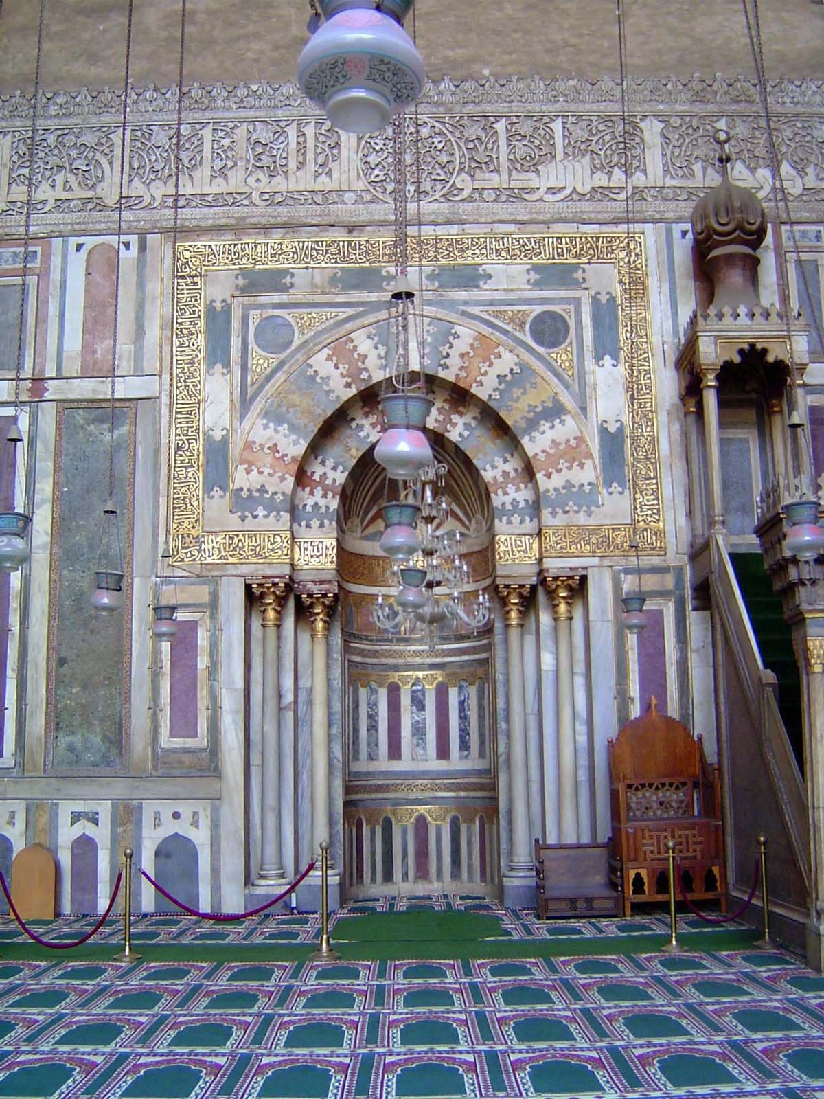 Before we go inside, here's the original polychrome marble mihrab with dado and a kufic inscription band next to a stone minbar, or pulpit.