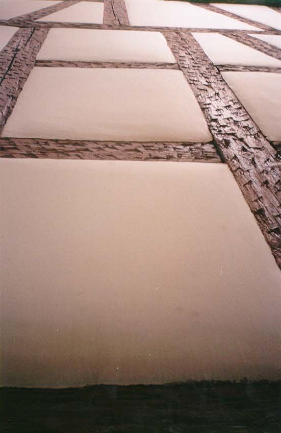 A half-timbered wall is so clean that, viewed from this angle, it looks like dough rising in breadpans.