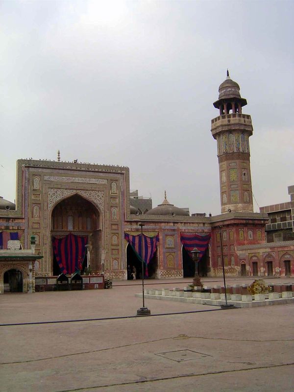 Inside, there's the familiar layout of a square courtyard facing a single-aisled prayer hall. The small building on the left marks the tomb 