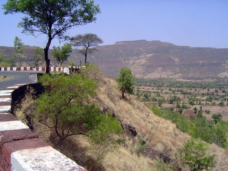 The climb begins. The British-era road can be seen slowly but steadily rising a bit over halfway up the slope in the distance.