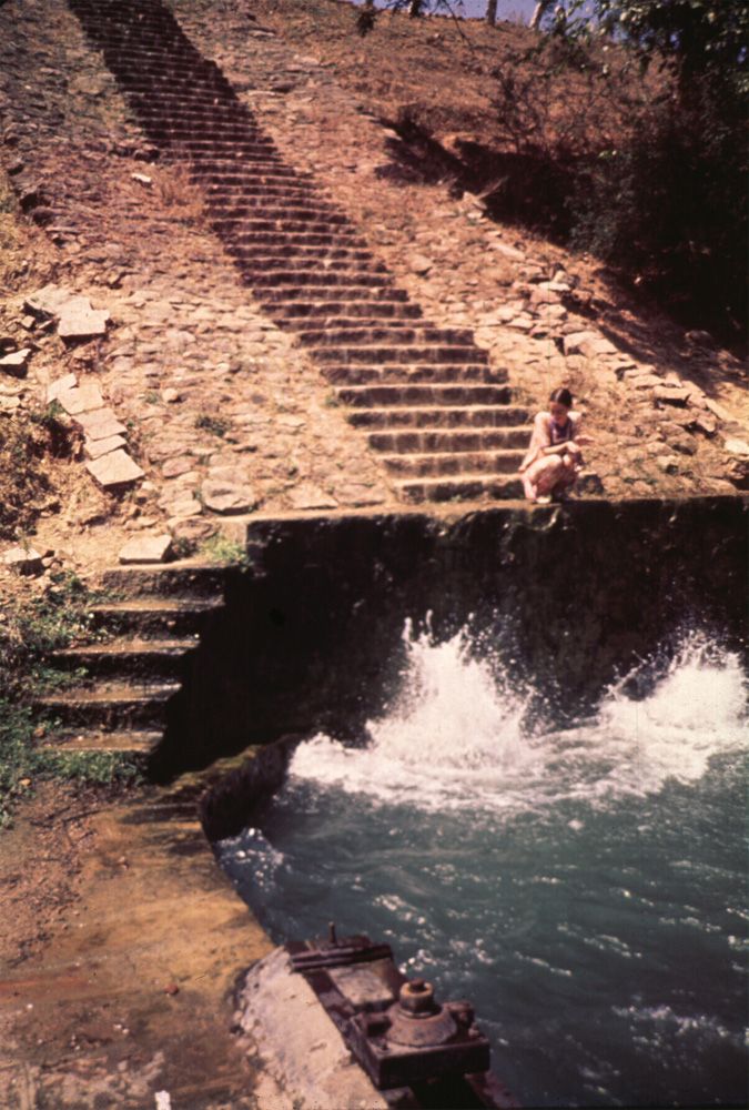 At the toe of the dam, an outlet tunnel releases water into a canal: this is paddy country, at least when the reservoir levels permit its cu