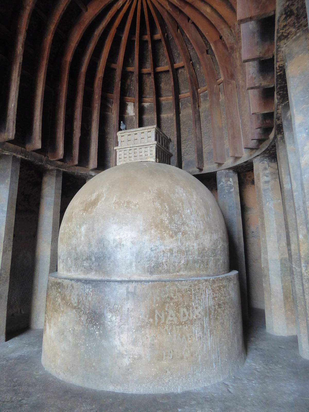 At the head of the cave there's a dagoba consisting of a cylinder, a dome, and a relic box and a pigeon. It's hard not looking instead at th