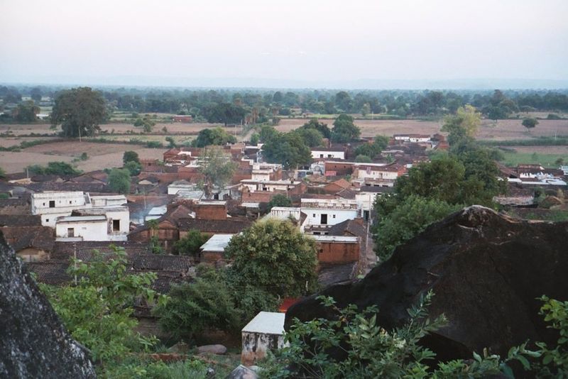 The village is at the toe of a granitic hill rising from a cultivated plain.