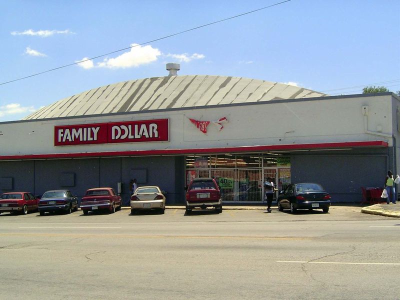 The competition is across the street: it's Family Dollar, in a building from 1950. Notice the accordion gate behind the plate glass.