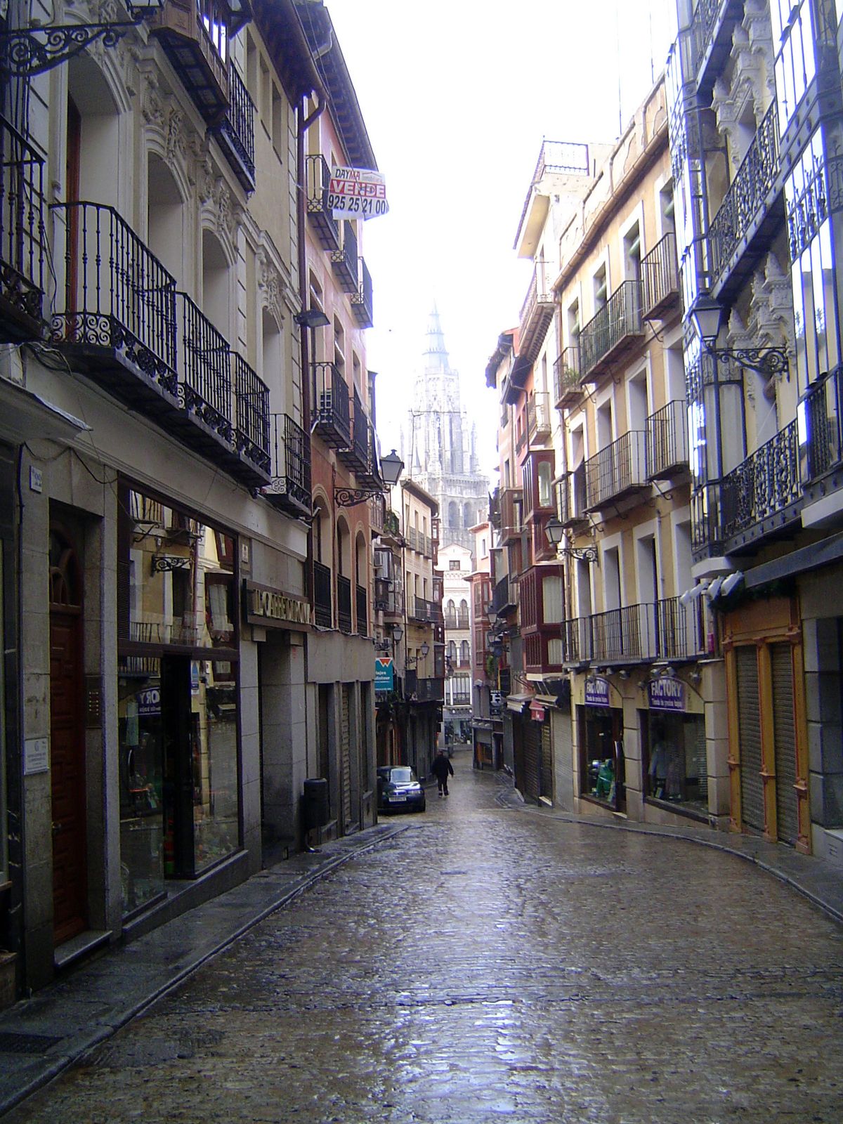 Ford writes: "Now a long and almost the only widish street in Toledo leads to the Gothic cathedral." Its spire looms early on a wet morning.