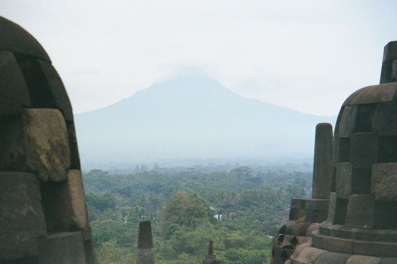 The clouds change rapidly, and the mountain emerges more clearly. It's an active volcano.