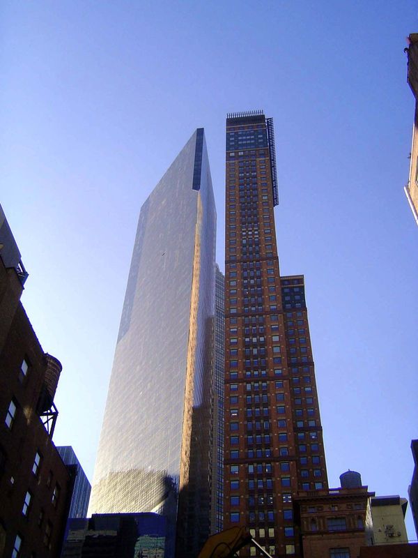 Shoulder to shoulder, the triangular Metropolitan Tower on the left stands next to Carnegie Towers, a "highrise Medici" office building by C