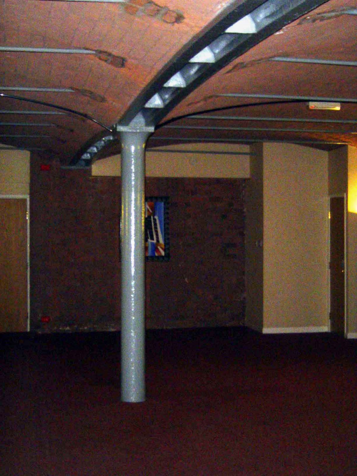 Inside, the floors are low brick arches resting on iron beams laid across iron posts. The iron in the column is an inch thick.
