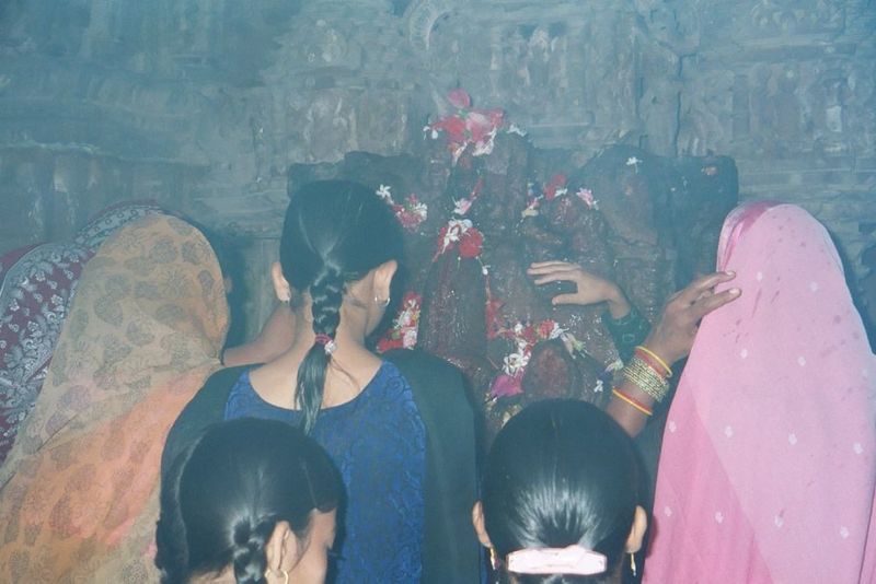 Inside, they cluster around a statue of the goddess.