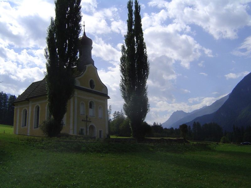 Down at the base of the valley there's some flat land, generally in pastures. Freestanding Catholic churches are common.