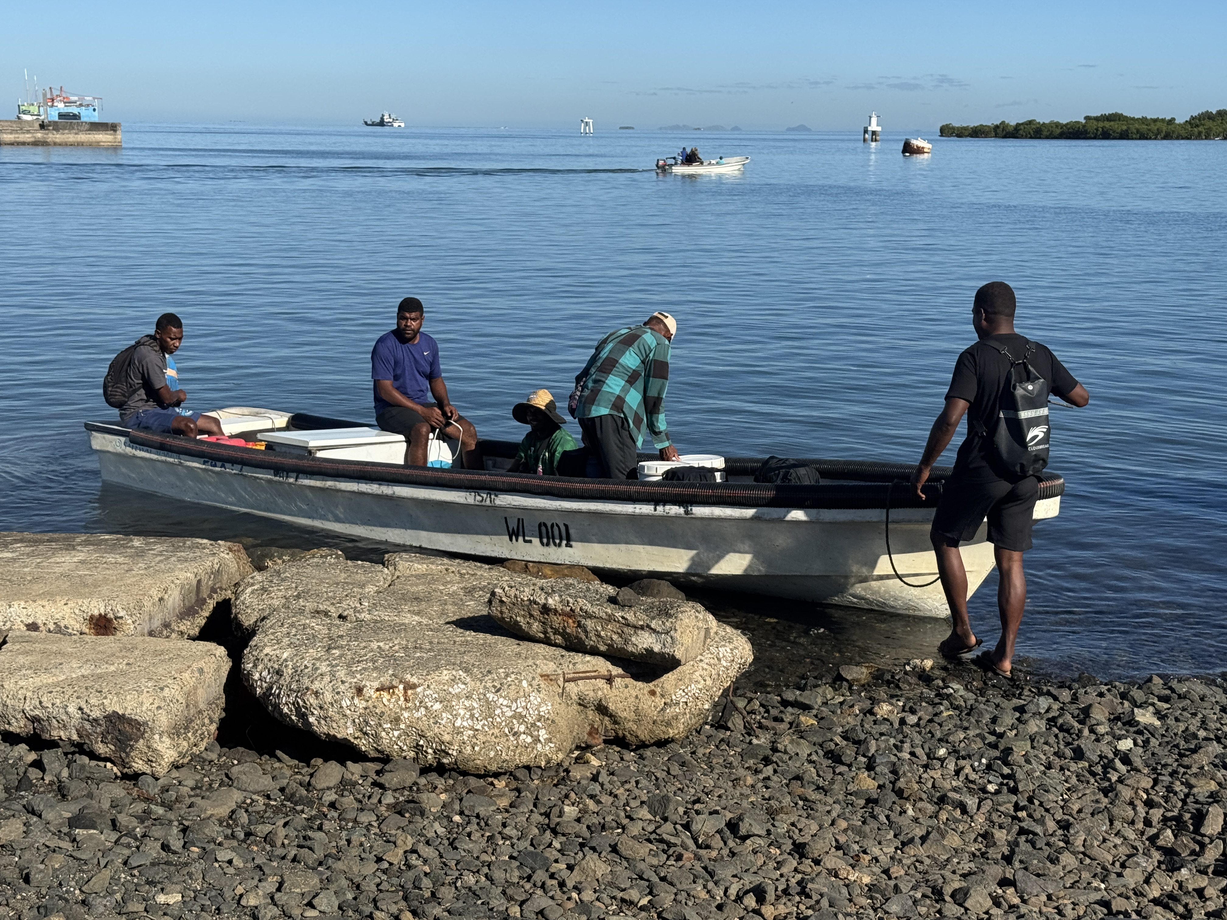 Close to the same wharf, a crew sets out to fish in shallow waters.  The catch will be sold at a nearby fish market.