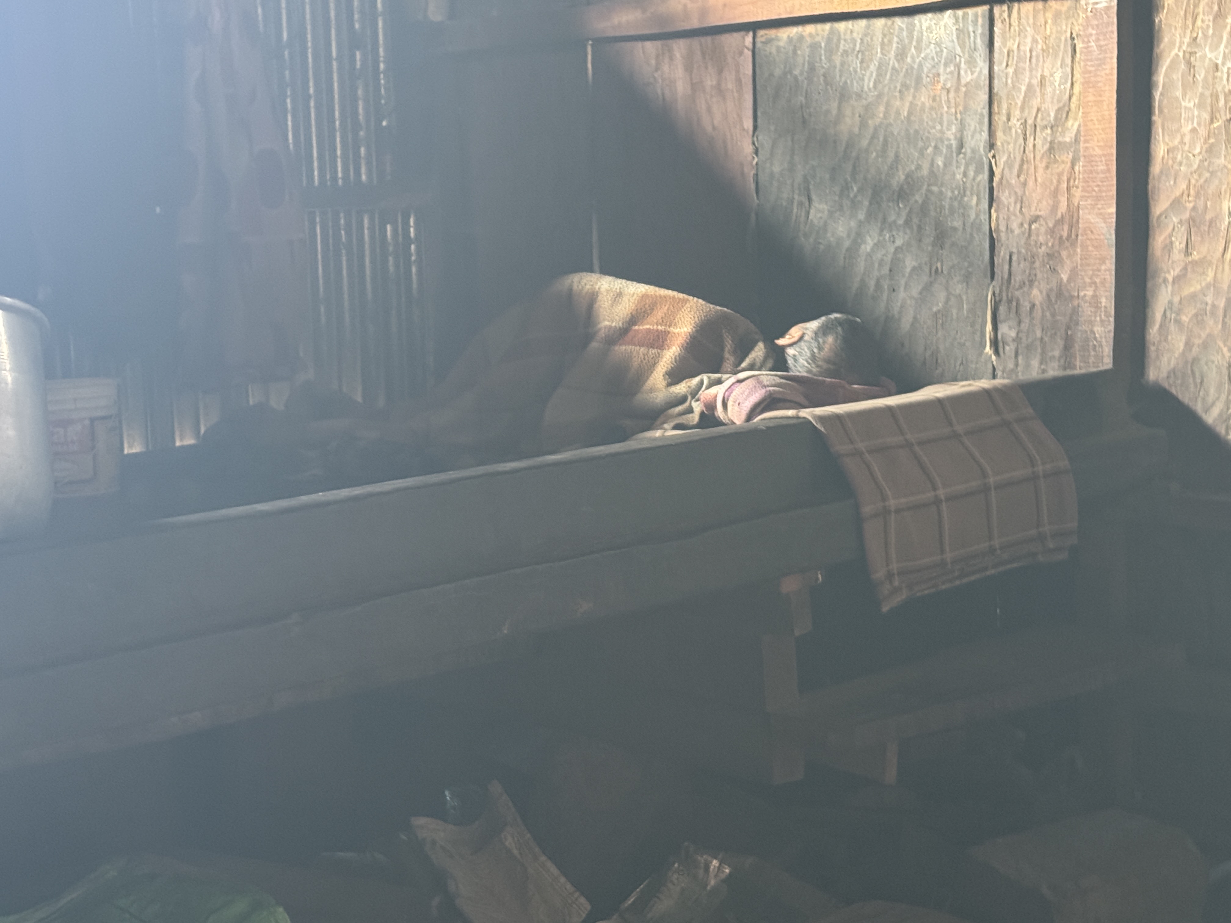 A boy asleep on one of the superduper king-size beds characteristic of Naga "bachelor dormitories" or morungs.