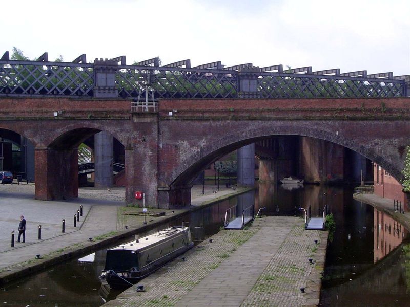 The terminus of the Bridgewater Canal, crossed by the MSJ & AR Viaduct of 1849 and, behind it, the steel Cheshire Lines Viaduct of 1877.