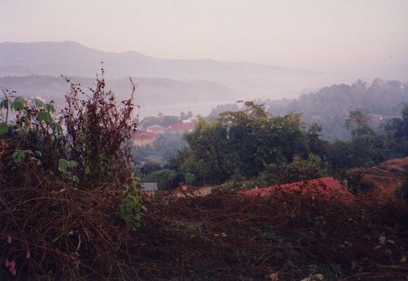 From the top of a nearby hill one sees Thailand, the Mekong, and the roofs of Houayxay.