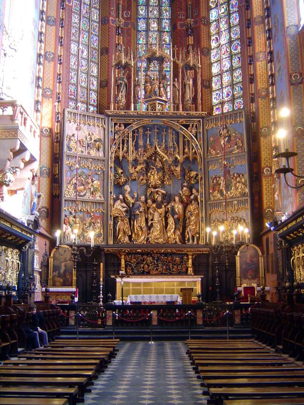 The Virgin appears three times on the altar: below at her death; above at the assumption; and up top at her coronation as queen of heaven. T