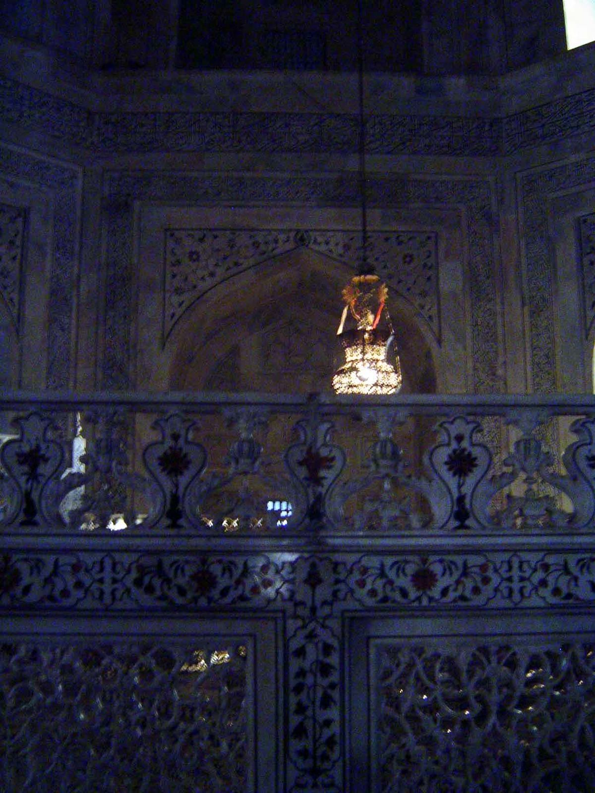 The cenotaph is screened by marble trellis-work jalis. The hanging lamp was ordered from Cairo by Curzon, who as viceroy took a serious inte