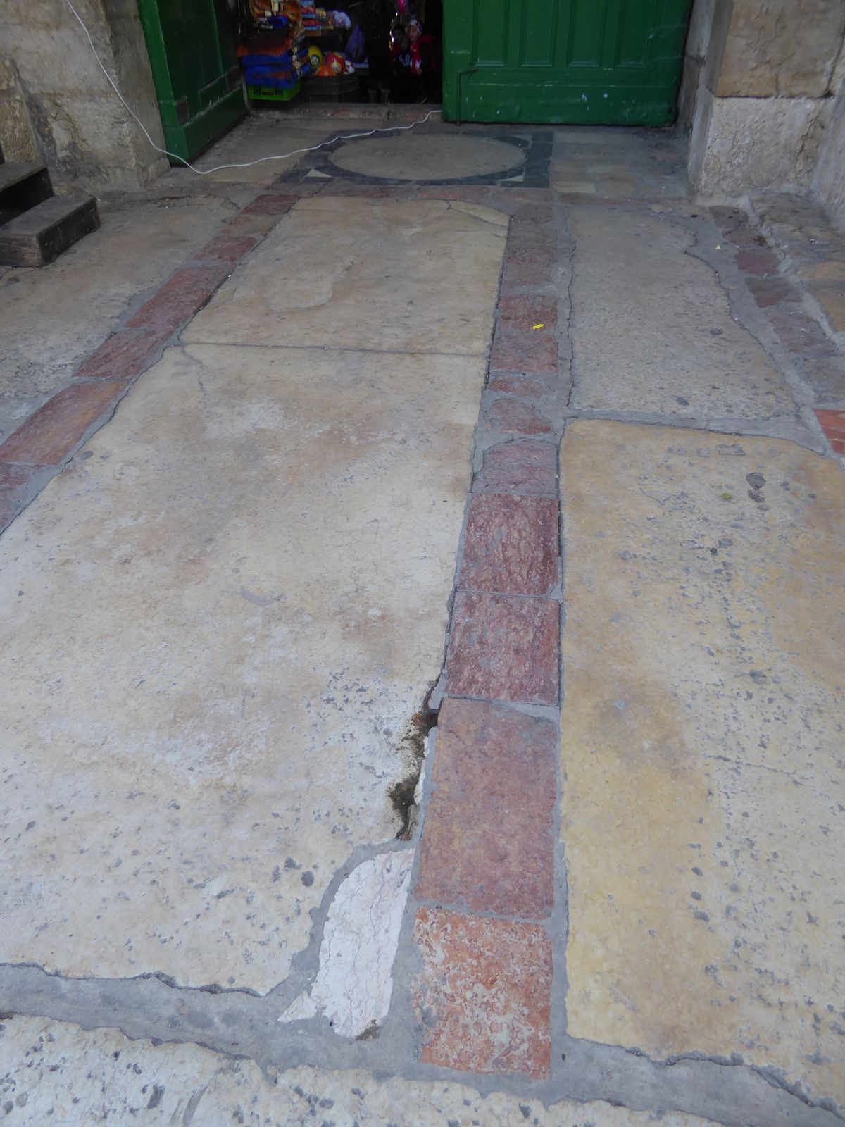 Neatly inlaid limestone in red, black, and yellow.