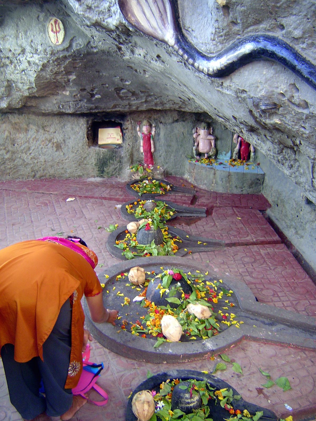 They lead to a very small marine cave, the Gangeshwar Temple, exposed at low tide. The figures have to be cut time and again as the waves er