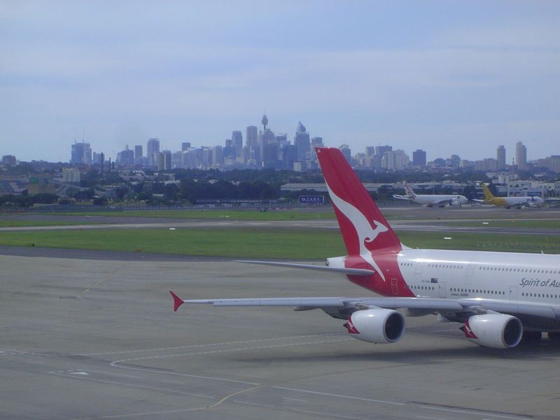Yes, that's one of the dozen A380's Qantas operates; no, it's not powering up, just taxiing. Yes, that's downtown Sydney in the distance; no