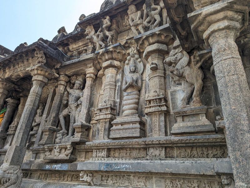 Busy, busy.  At the center, Manasa, the ancient and originally tribal snake goddess.  On the left, conceivably Siva as Kalasamharamurti, ste