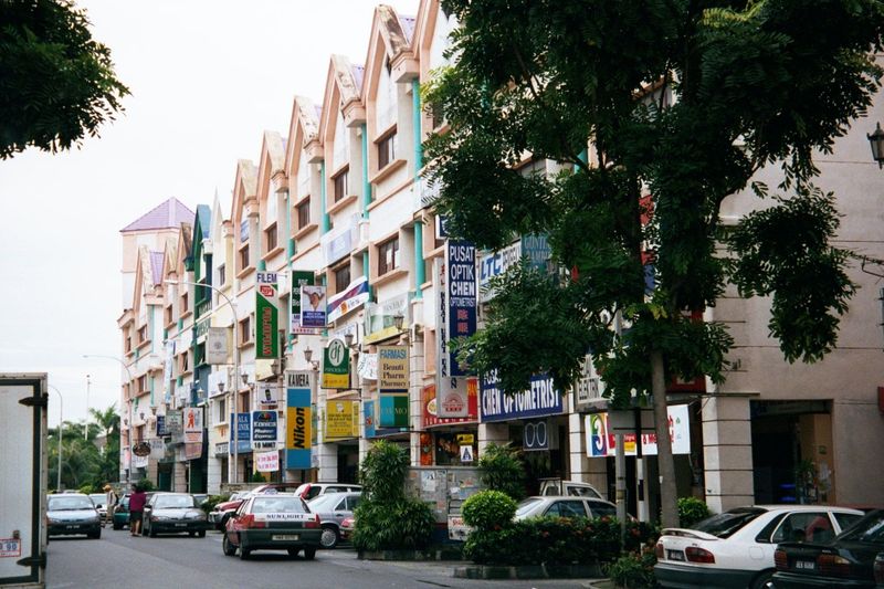 Perhaps ten miles to the west, a new shopping street echoes of the shophouses of a century past.