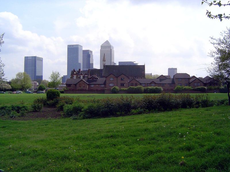 Canary Wharf seen behind Bartlett Park and St. Saviour's court, marked by a thin spire.