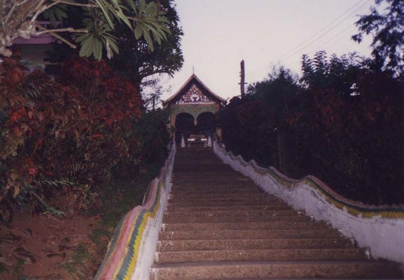 The Wat Jawn Khao looks down on the street. The stairs are flanked by rippling nagas, mythical serpents.