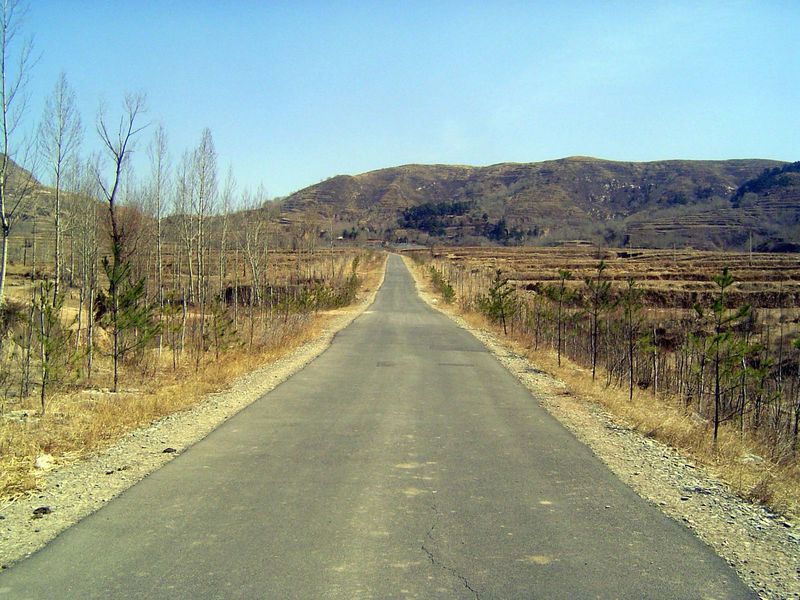 Terraced fields, barren mountains, improved road.