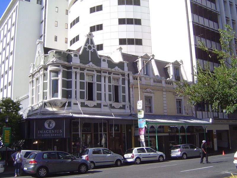 Somebody forgot the turret! The curved corner window formerly displayed a life-size statue of a woman.

When completed in 1899 to a design b