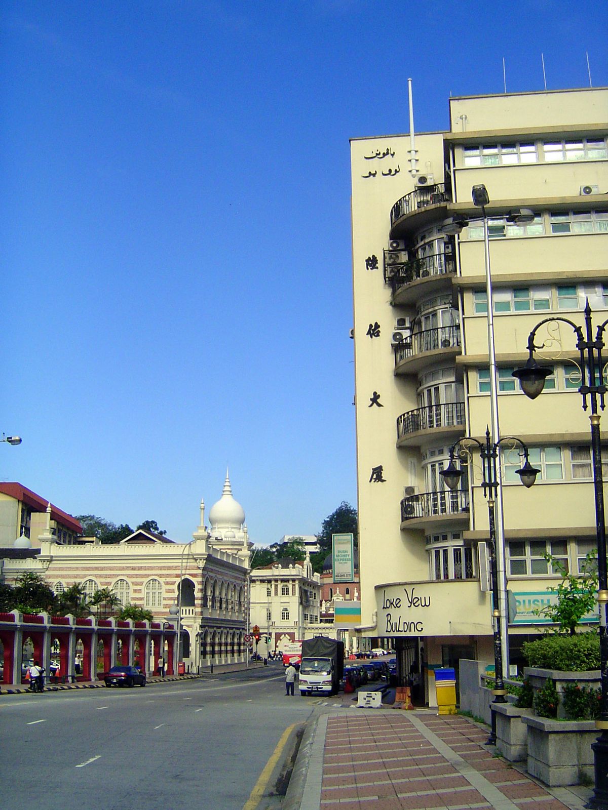 We're on a bridge over the Klang River; that's the old railway office building in the distance. On the right, the Loke Yew Building, which a