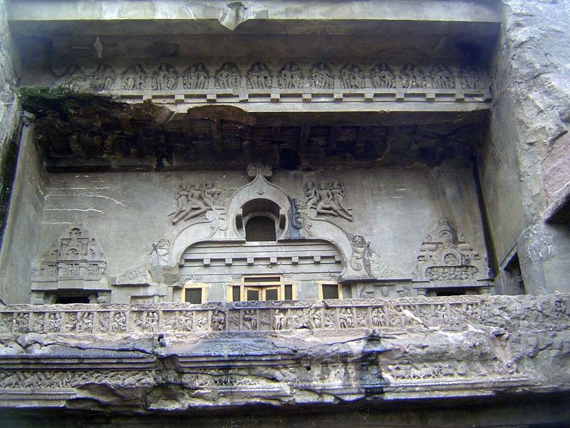 The upper level has flying figures around a window that shines into the room behind.
