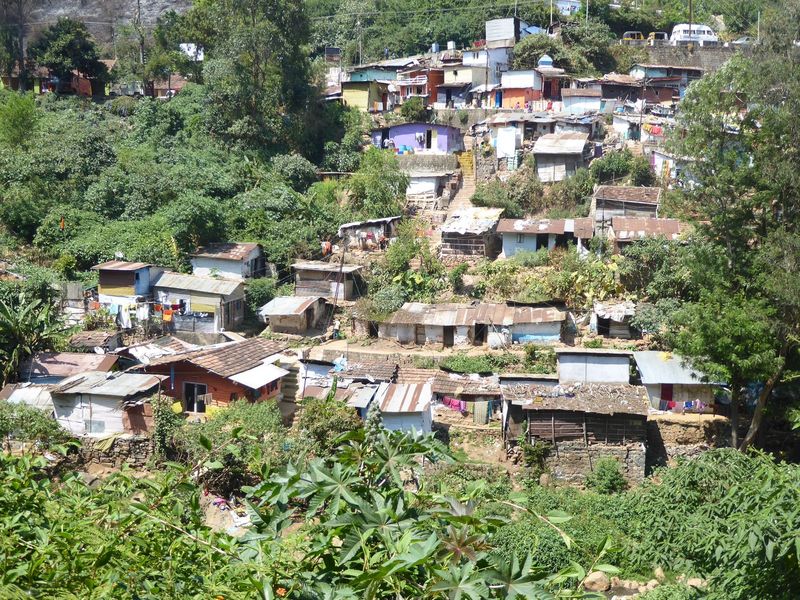 Outside town, houses march up hillsides.