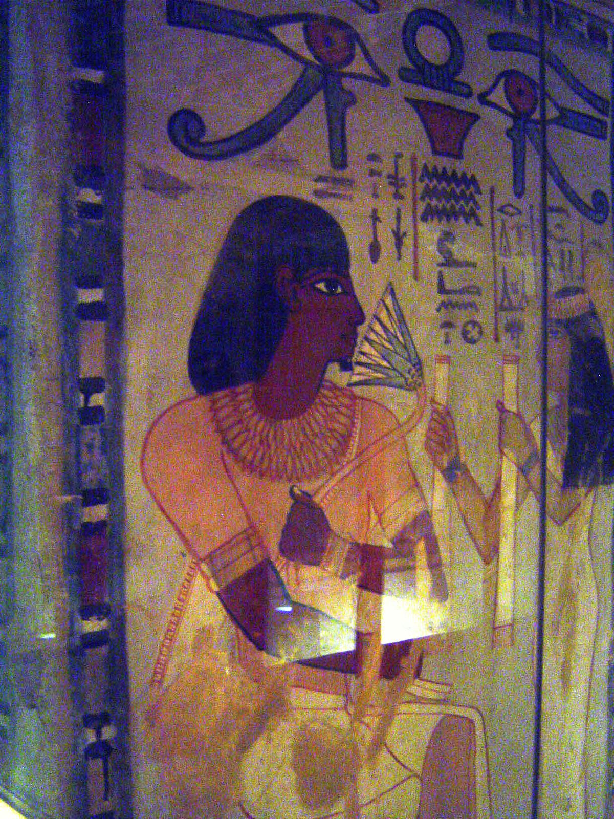 The room has several massive piers, decorated but now covered with protective glass. Here, behind a sheet of it, Sennefer smells a lotus flo