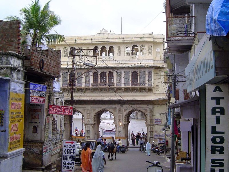 Now we've stepped back from the ghat and are seeing it through another Tripolia, added in 1878. It's the waterside entrance to another palac