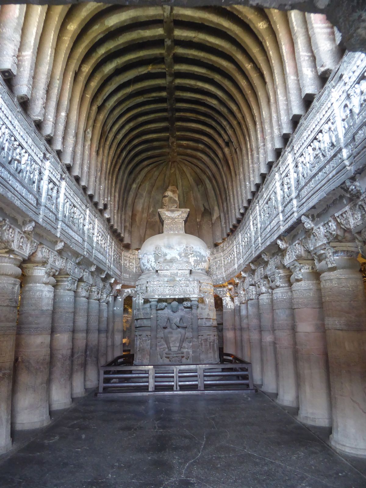 Here's Cave 26, with the Buddha again integral to the stupa but shown, in the style of the slightly later day, sitting on a throne. The para