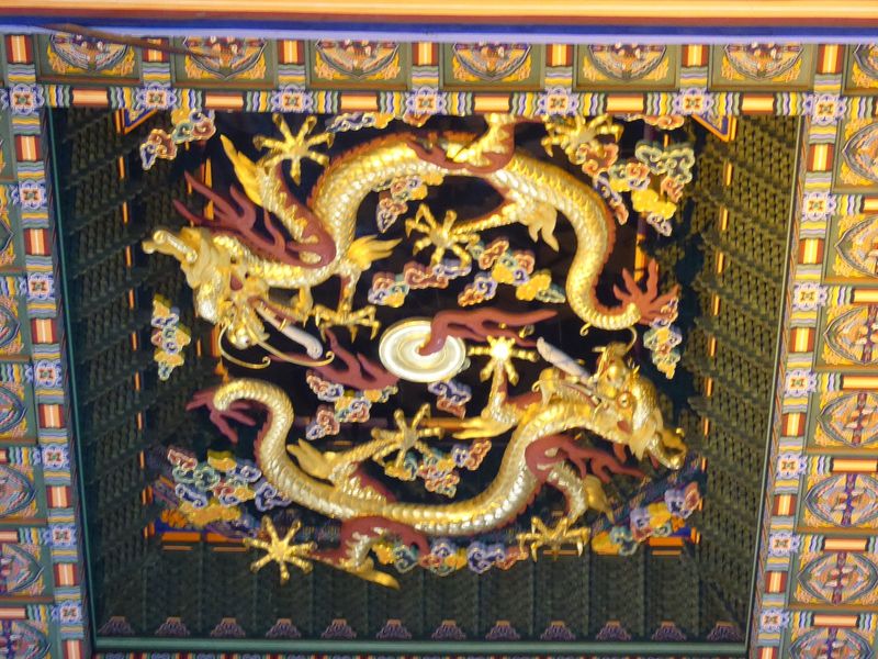 Up top, clouds and dragons circle the throne.