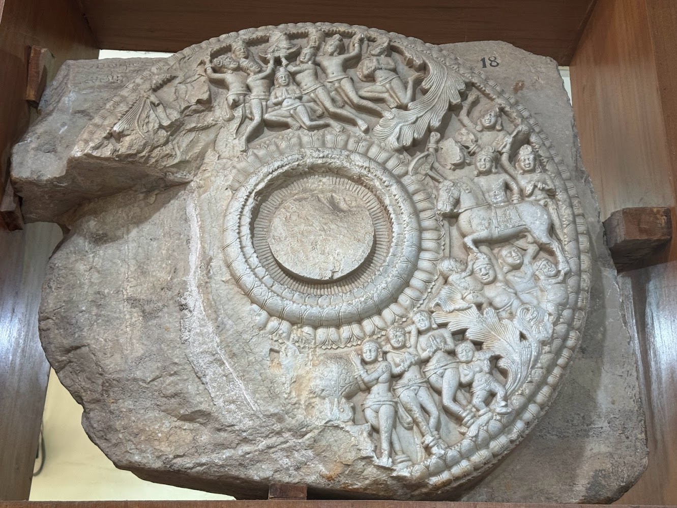 Accession 155, a medallian with three stories: at the top, goddesses carry the Buddha represented by a stupa; on the right the horse Kanthak