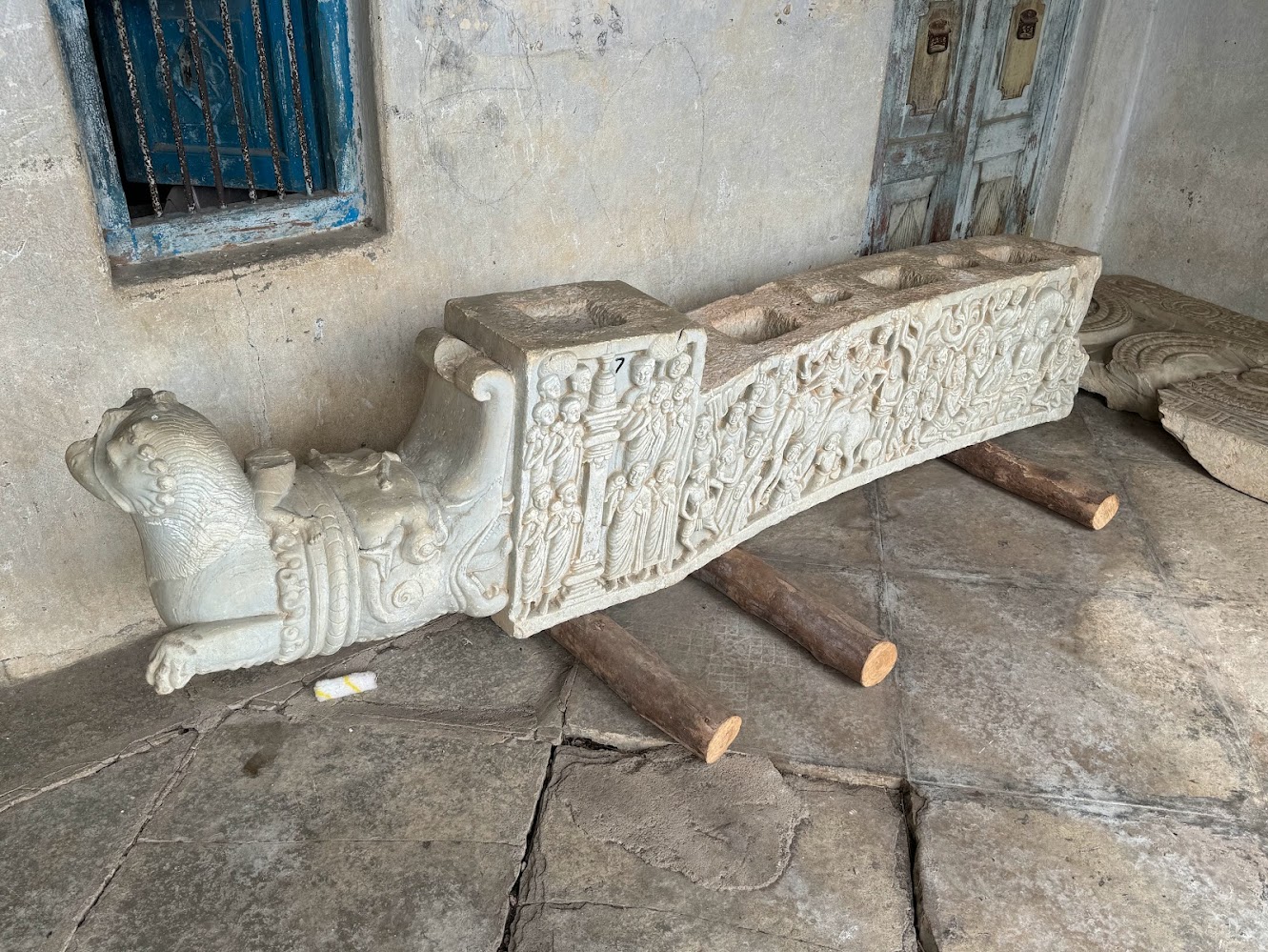 Yikes!  It's a broken cross piece from a torana gateway of the sort reconstructed at Sanchi and unknown elsewhere in South India.