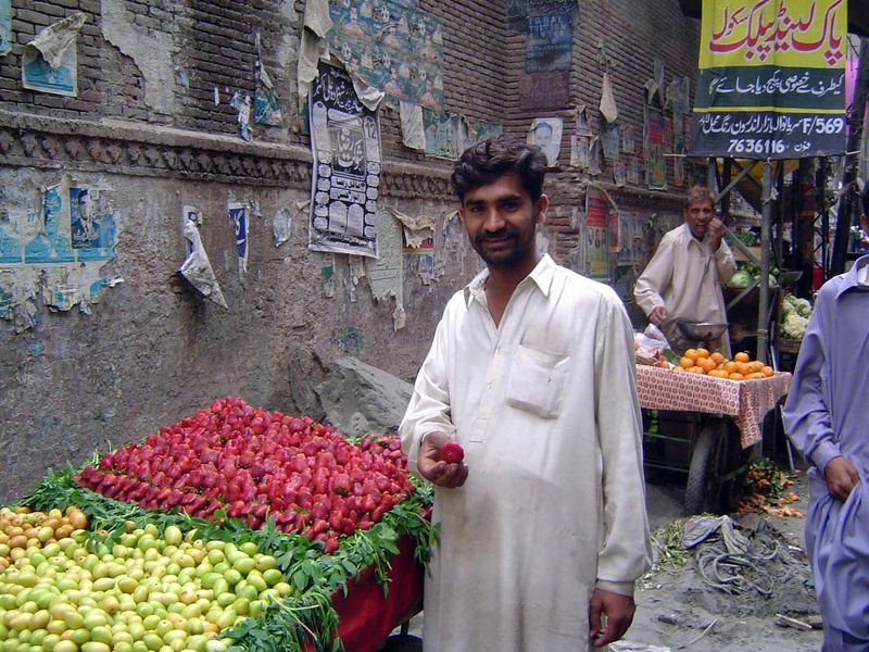 A vendor with very red strawberries.