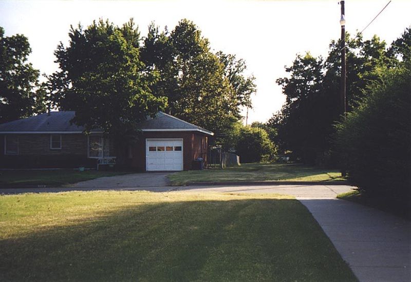 Standing in the access path and looking back to the street and the access path to the park in the adjacent block. An elementary school sits 