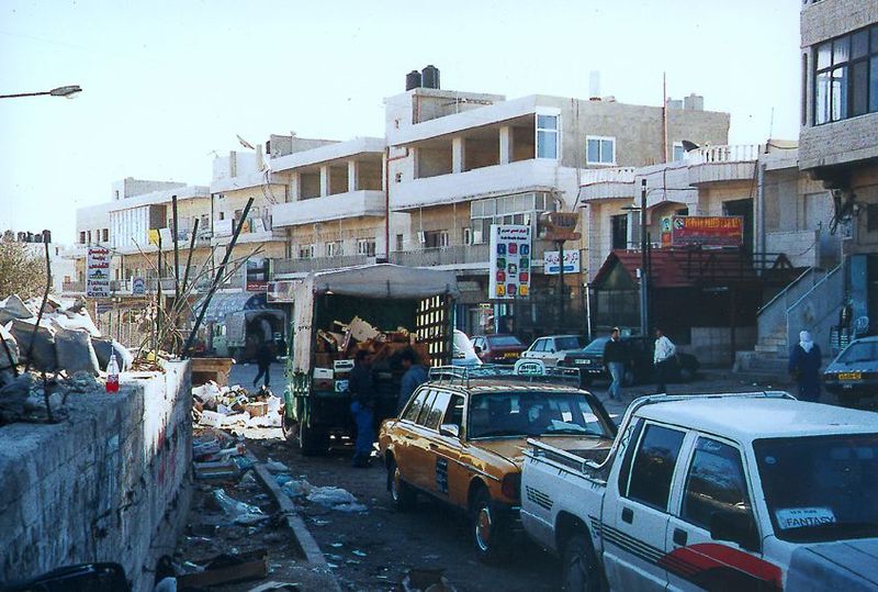 The main junction in Abu Dis, where roads and bus lines converge in a commercial center grievously untended.