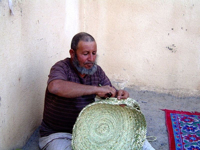 There's a scattering of people still in the old town; here, a creative use for palm leaves.