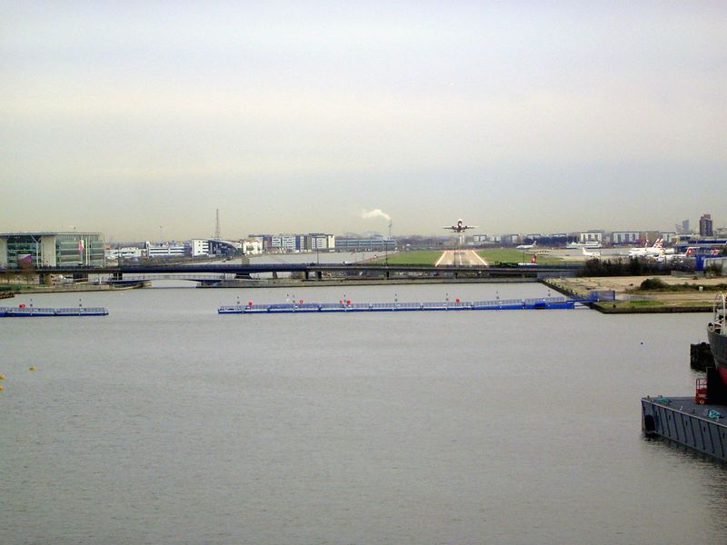 Zooming east from the midpoint on that bridge, the camera takes in the Albert Dock beyond the bridges. The London City Airport opened in 198
