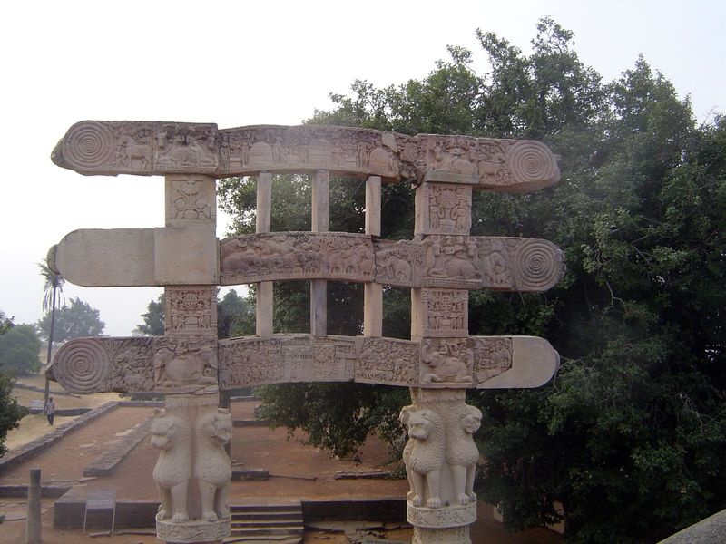 Rear of south gateway. The top and bottom architraves, mistakenly mounted back to front in the 1880s, show the seven Buddhas of this eon and