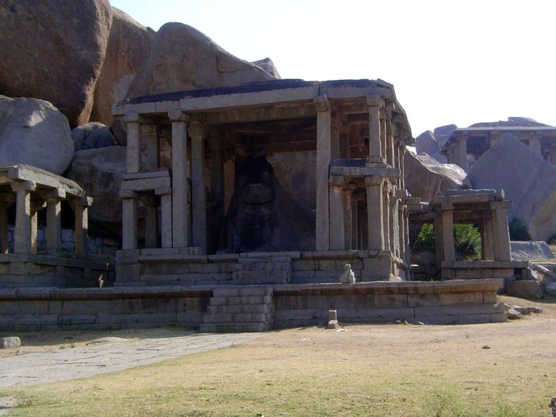 The stone frame in this case houses a monolithic Nandi, arranged conventionally to face the temple of his master, several hundred yards to t