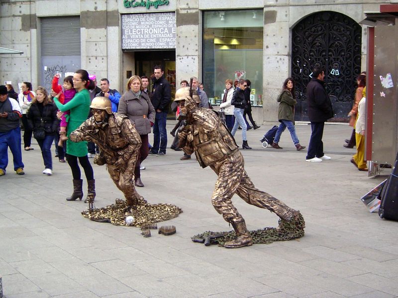 A score or more of living statues, many in seemingly impossible poses, are more striking than the bronze ones.